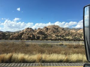 A beautiful pure rock formation on the left driver's side of the highway.