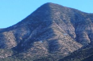 A big rock mountain standing under a clear sky in New Mexico