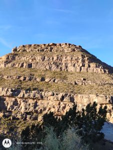 A massive rock mountain in New Mexico standing tall, showcasing enduring strength and steady beauty under the sky.